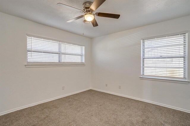 spare room featuring a textured ceiling, carpet floors, and ceiling fan