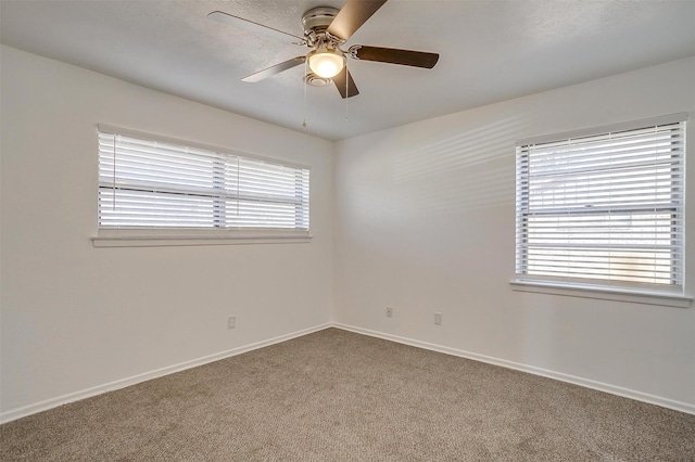 spare room featuring ceiling fan and carpet flooring