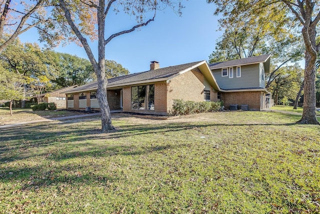 back of property featuring a yard