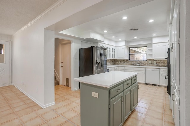 kitchen featuring decorative backsplash, a kitchen island, dishwasher, stainless steel fridge with ice dispenser, and white cabinetry