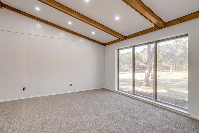 carpeted spare room featuring vaulted ceiling with beams