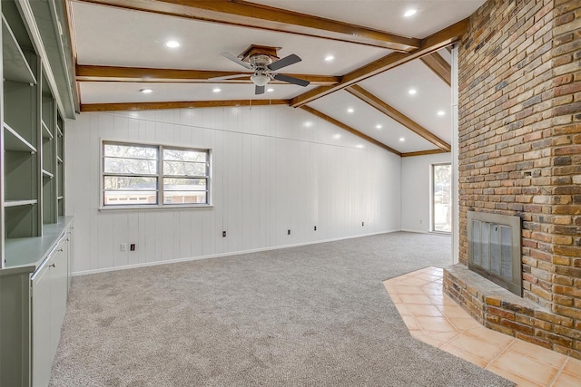 unfurnished living room featuring vaulted ceiling with beams, ceiling fan, a fireplace, and light carpet