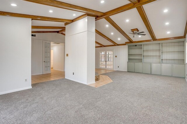 unfurnished living room with vaulted ceiling with beams, light carpet, french doors, and ceiling fan