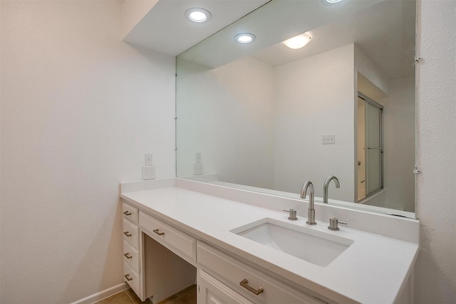 bathroom with vanity and a shower with shower door