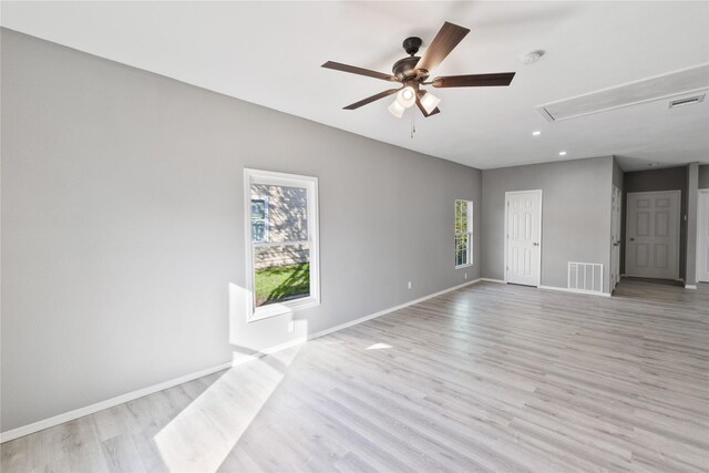 unfurnished living room featuring ceiling fan and light wood-type flooring