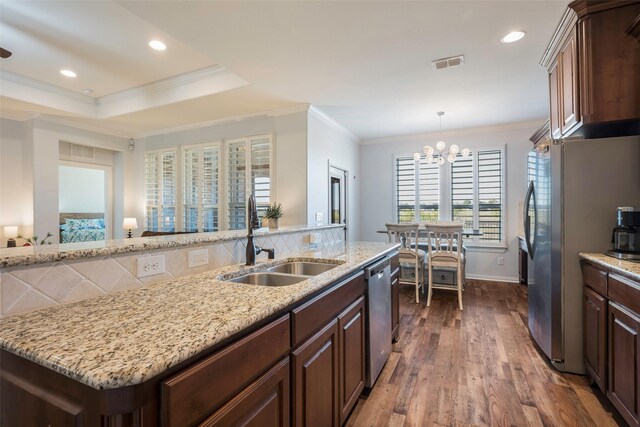 kitchen featuring sink, dark wood-type flooring, crown molding, a chandelier, and appliances with stainless steel finishes