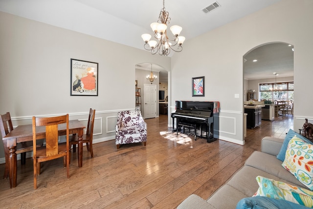 living room with hardwood / wood-style floors and a chandelier