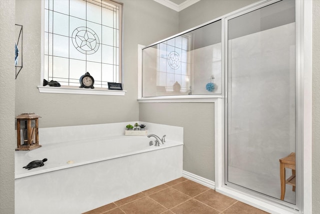 bathroom with tile patterned flooring, crown molding, and shower with separate bathtub