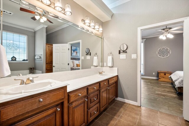 bathroom featuring tile patterned floors, ornamental molding, and vanity