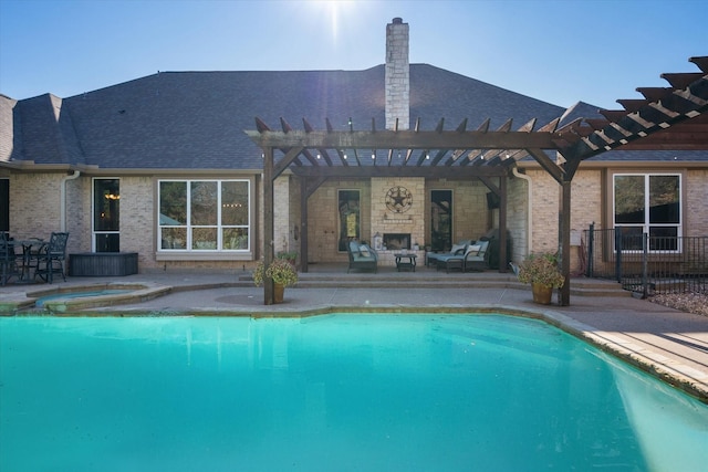 view of swimming pool with an in ground hot tub, a fireplace, a pergola, and a patio