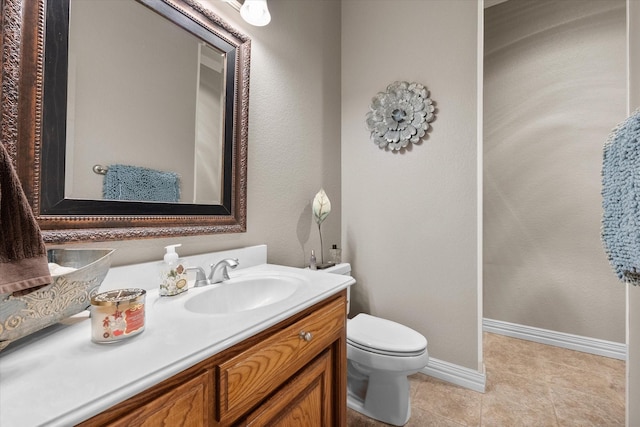 bathroom with vanity, toilet, and tile patterned flooring