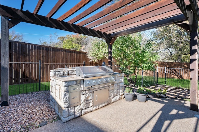 view of patio / terrace with an outdoor kitchen and a pergola