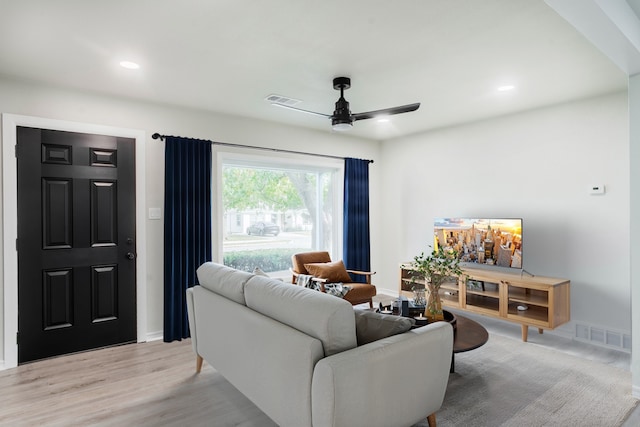 living room with ceiling fan and light wood-type flooring