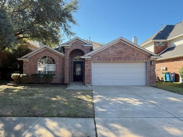 view of property with a garage and a front yard