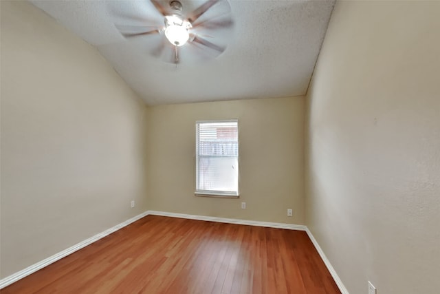 unfurnished room with hardwood / wood-style floors, a textured ceiling, ceiling fan, and lofted ceiling