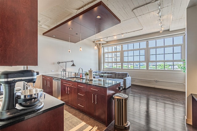 kitchen featuring dark hardwood / wood-style floors, a center island, sink, and track lighting