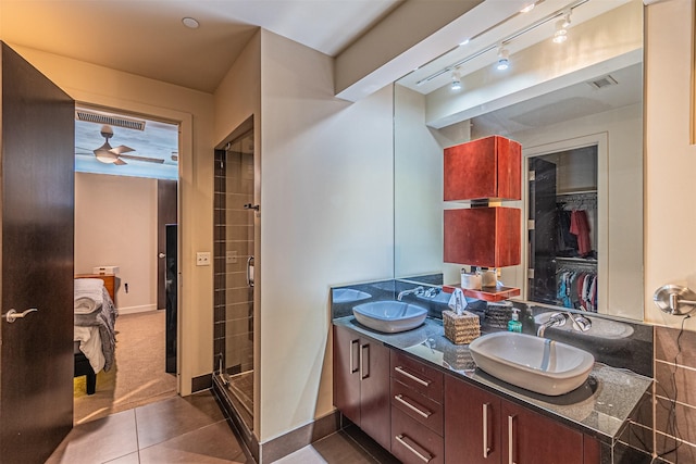 bathroom featuring tile patterned flooring, vanity, ceiling fan, and walk in shower