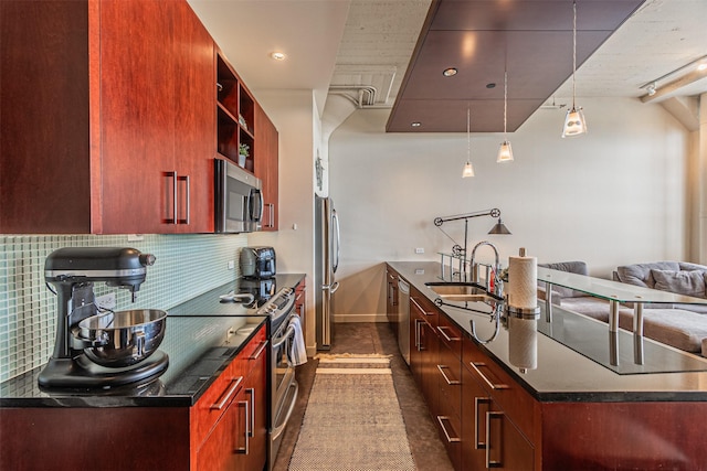 kitchen with backsplash, stainless steel appliances, sink, dark tile patterned flooring, and hanging light fixtures