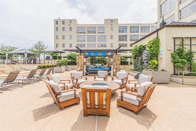 view of patio with a gazebo, a pergola, and an outdoor living space with a fire pit