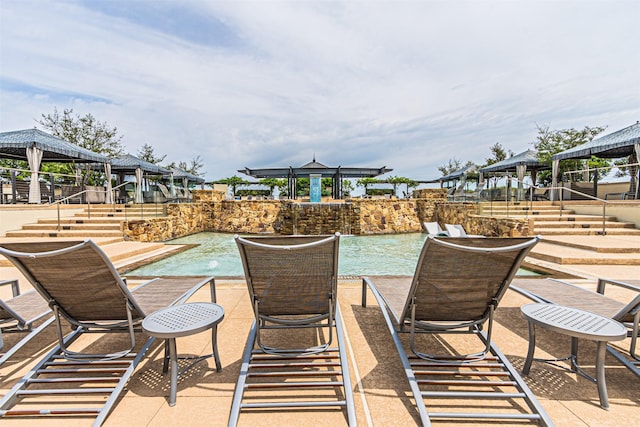 view of patio with a gazebo and pool water feature