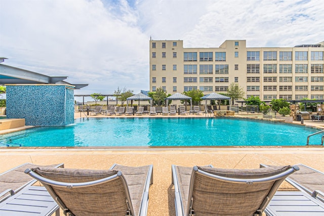 view of swimming pool with a gazebo, a patio area, and pool water feature