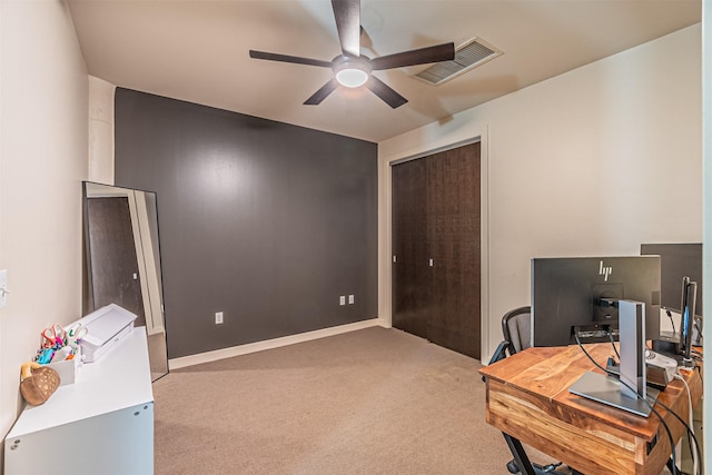 carpeted home office featuring ceiling fan