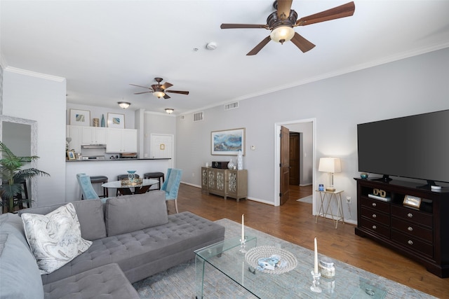 living room featuring dark hardwood / wood-style flooring and crown molding