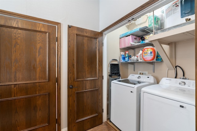 laundry area with independent washer and dryer