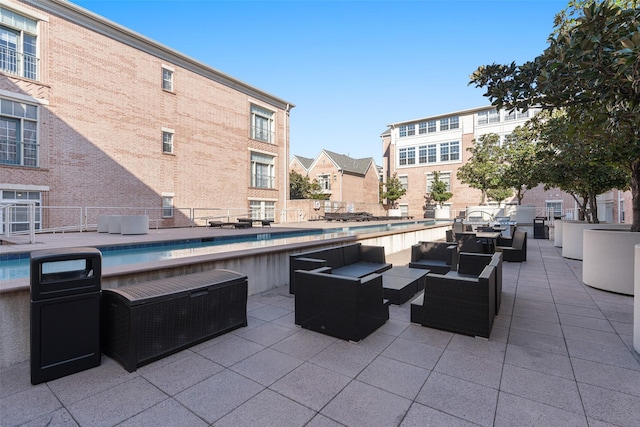 view of patio with outdoor lounge area and a fenced in pool