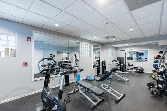 exercise room featuring plenty of natural light and a drop ceiling