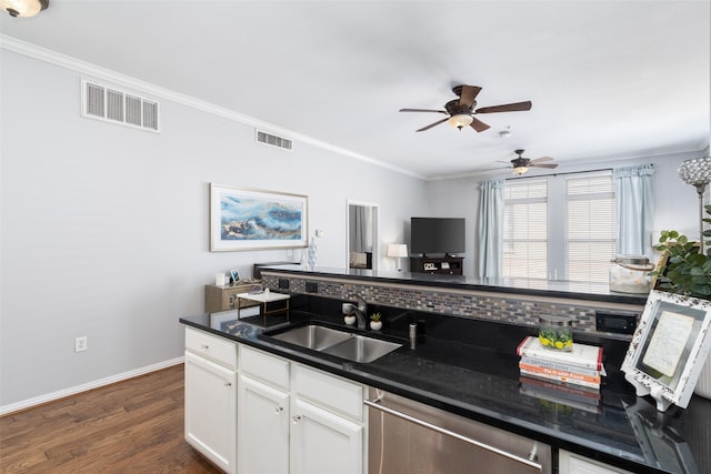 kitchen with sink, white cabinets, stainless steel dishwasher, and ornamental molding