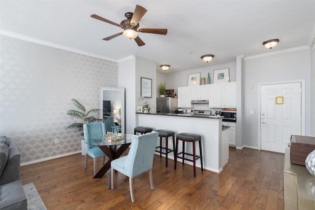 dining area with crown molding, dark hardwood / wood-style flooring, and ceiling fan