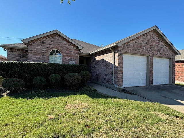 ranch-style house featuring a garage and a front lawn