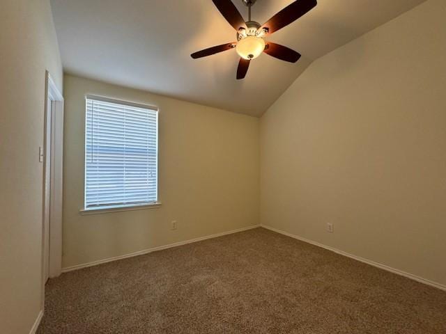 carpeted spare room featuring ceiling fan and lofted ceiling