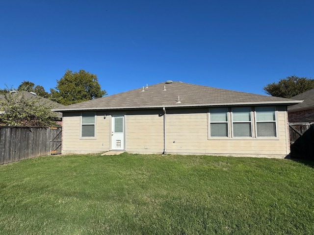 back of property featuring a lawn