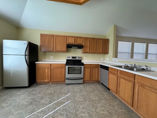 kitchen with tile patterned floors, sink, vaulted ceiling, and appliances with stainless steel finishes