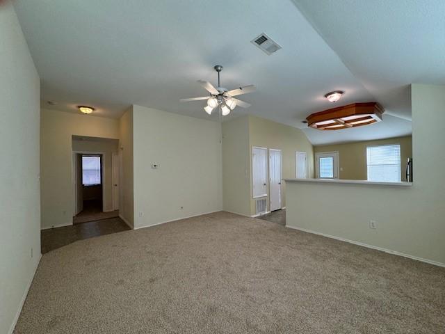 empty room with carpet flooring, ceiling fan, and lofted ceiling