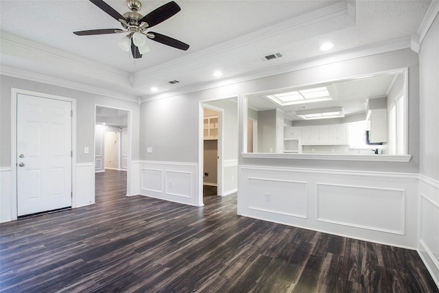 spare room with ceiling fan, ornamental molding, a tray ceiling, and dark hardwood / wood-style flooring