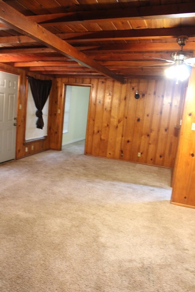 basement with wood ceiling, wooden walls, and carpet