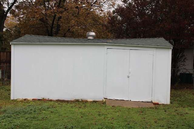 view of outdoor structure featuring a lawn