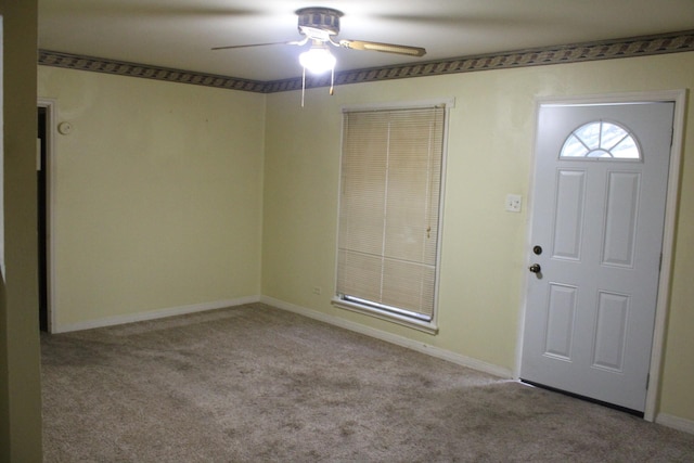 carpeted entrance foyer featuring ceiling fan