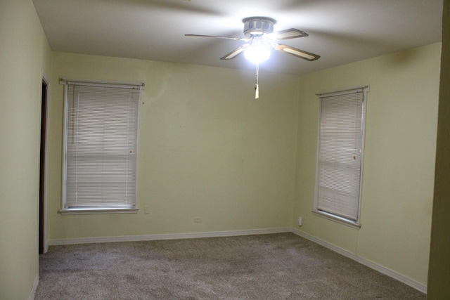 empty room with light colored carpet and ceiling fan