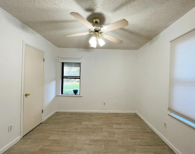 unfurnished room with ceiling fan, light hardwood / wood-style floors, and a textured ceiling