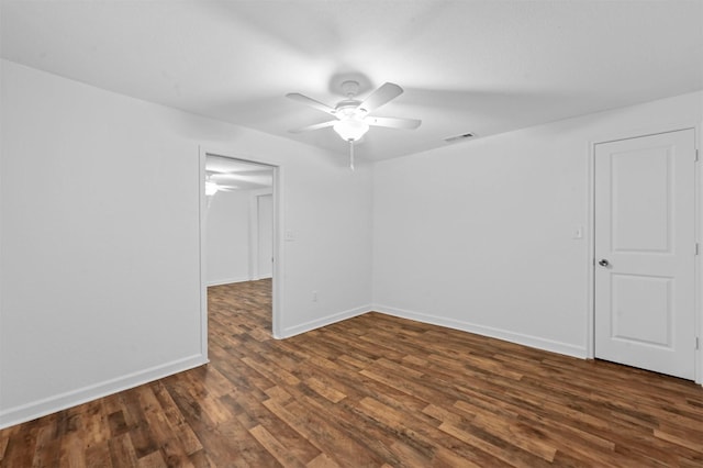 empty room with dark hardwood / wood-style floors and ceiling fan