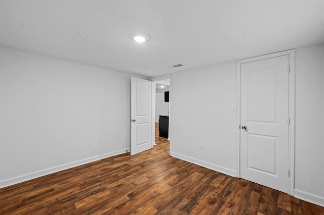 spare room with dark hardwood / wood-style floors