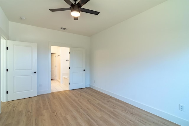 unfurnished bedroom with light hardwood / wood-style floors, ensuite bath, and ceiling fan