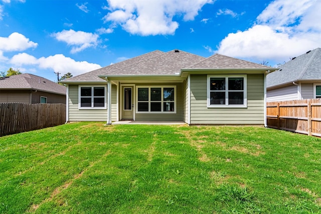 back of house with a lawn