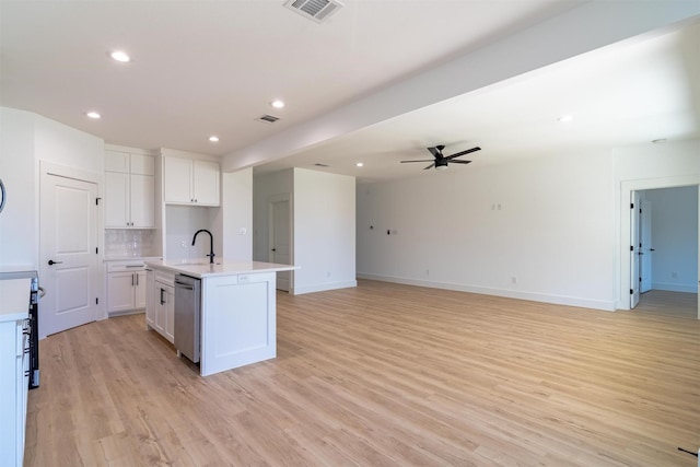 kitchen with white cabinetry, ceiling fan, stainless steel dishwasher, a kitchen island with sink, and light wood-type flooring