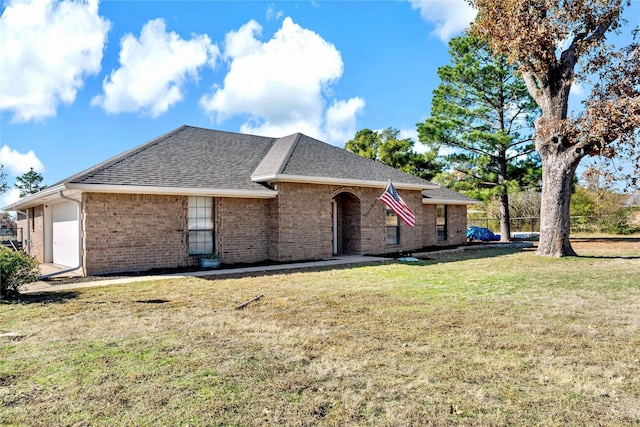 exterior space featuring a garage and a front yard