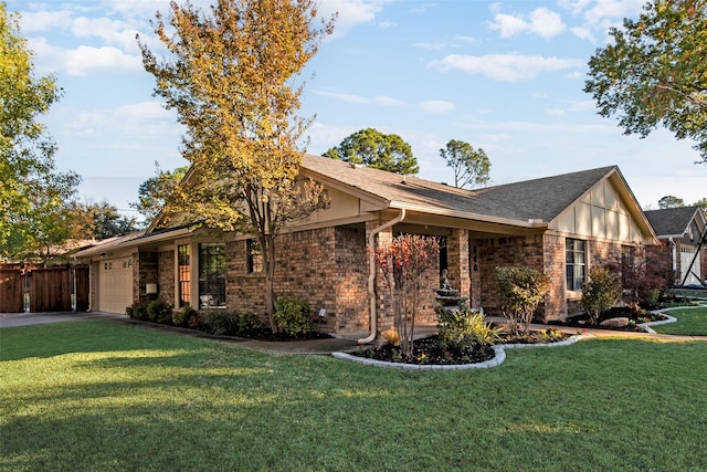 view of front of property featuring a front lawn and a garage